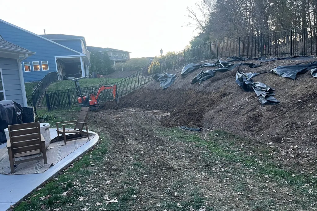 Workers excavating a trench for the footer of a retaining wall